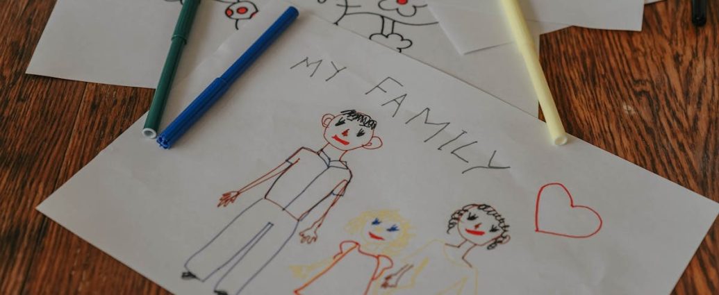 A hand-drawn family portrait using colored markers on paper, showcasing creativity and love.